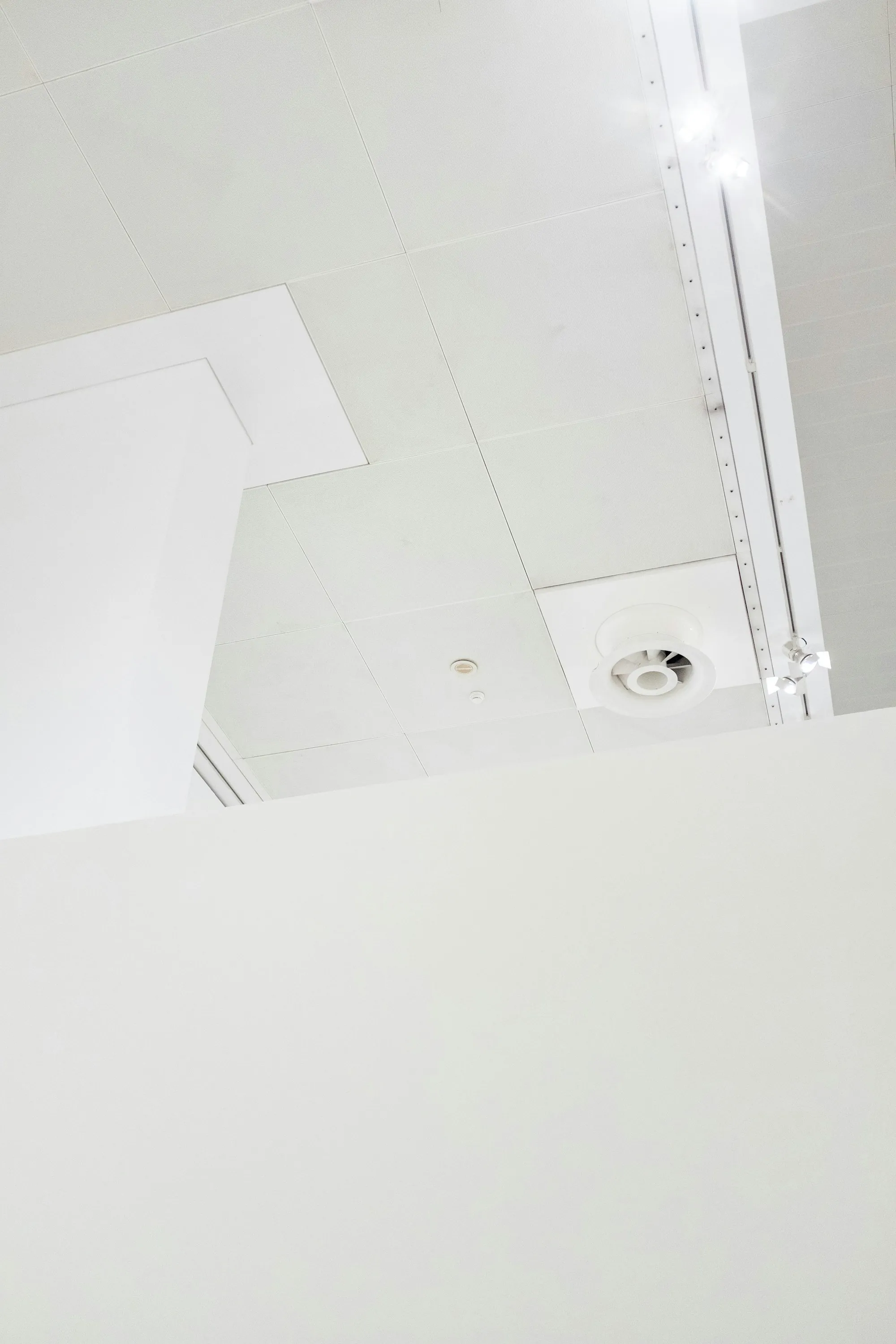 Ceiling air diffuser in a white drop ceiling